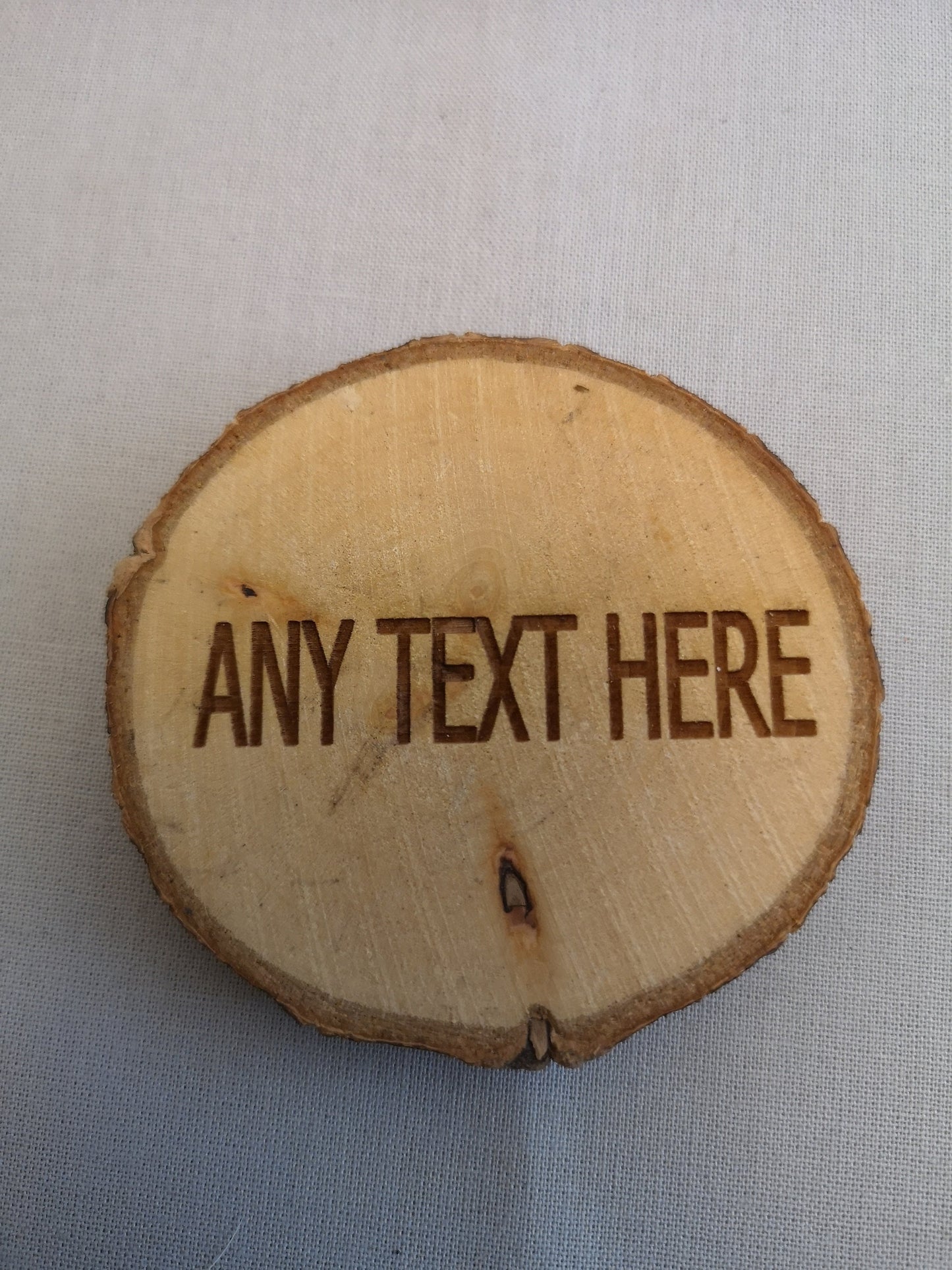 Rustic handmade laser engraved wooden slices.
